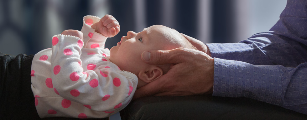 Dr. Eric Gislason evaluating a baby
